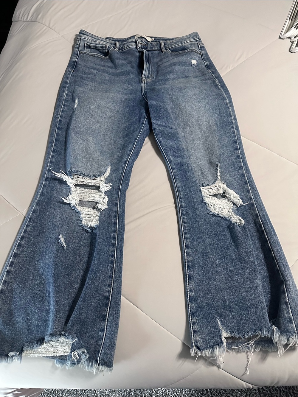 Distressed Blue Flare Jeans with Raw Hem